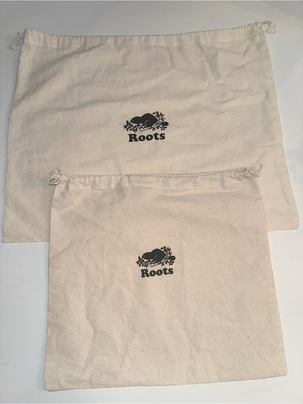 Roots Natural Canvas Drawstring Bags with Black Logo Dust Bags